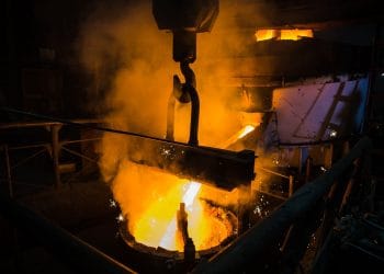 Molten steel pouring. Liquid hot metal of steel spills out of the ladle at steel factory